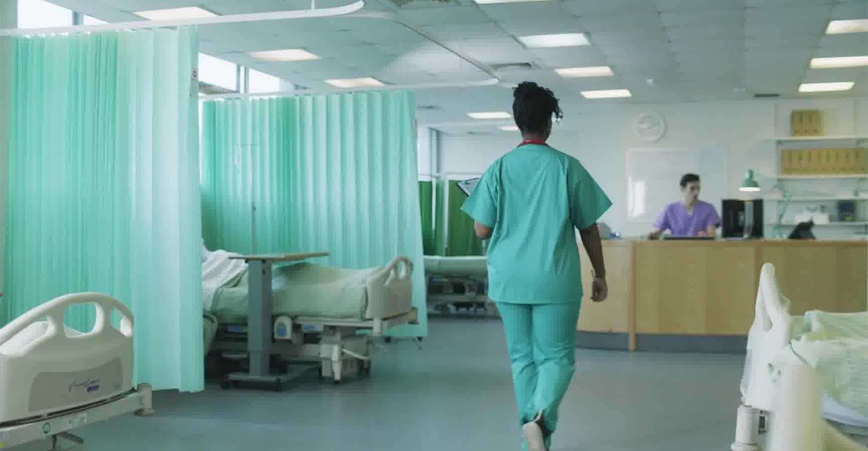 Nurse walking towards a front desk