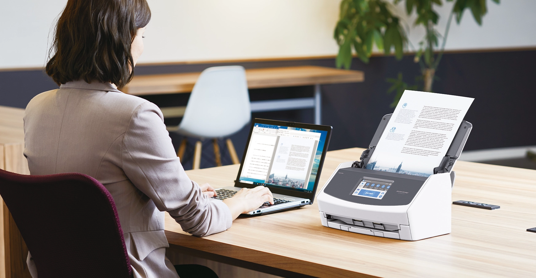 Lady on her desk scanning a document with a ScanSnap scanner