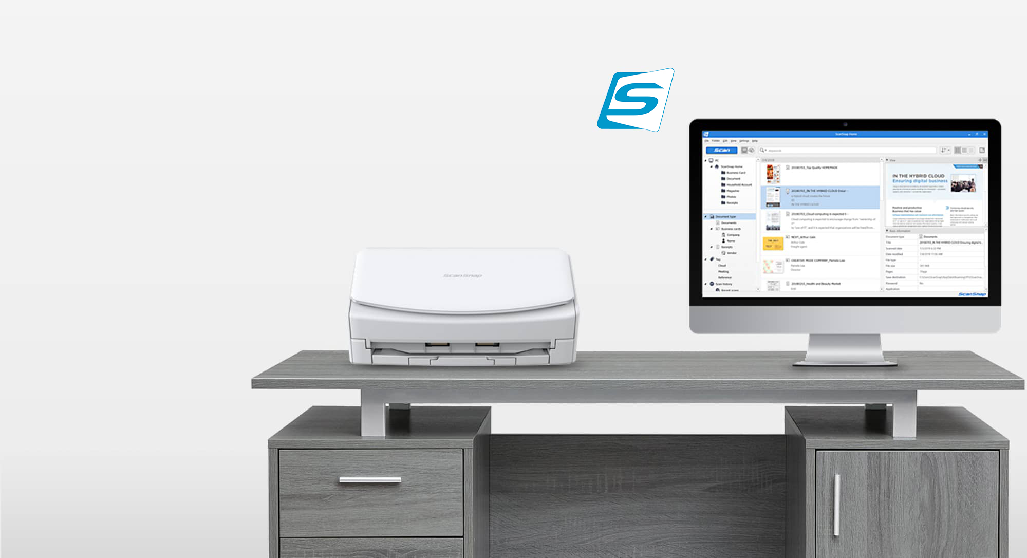 white ScanSnap scanner shown on a desk next to a computer screen